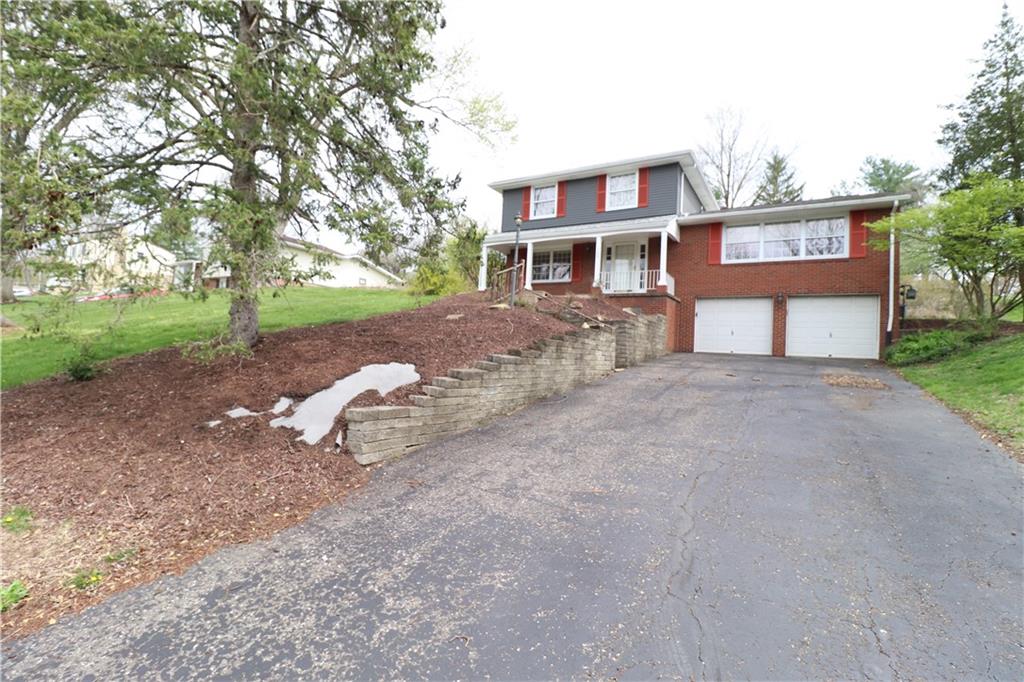 164 Friar Lane McMurray, PA 15317 - Photo 2 of 46 a front view of a house with a yard and garage