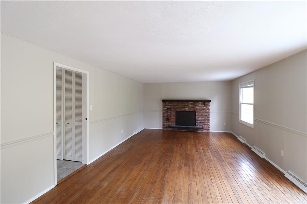 164 Friar Lane McMurray, PA 15317 - Photo 21 of 46 an empty room with wooden floor fireplace and windows