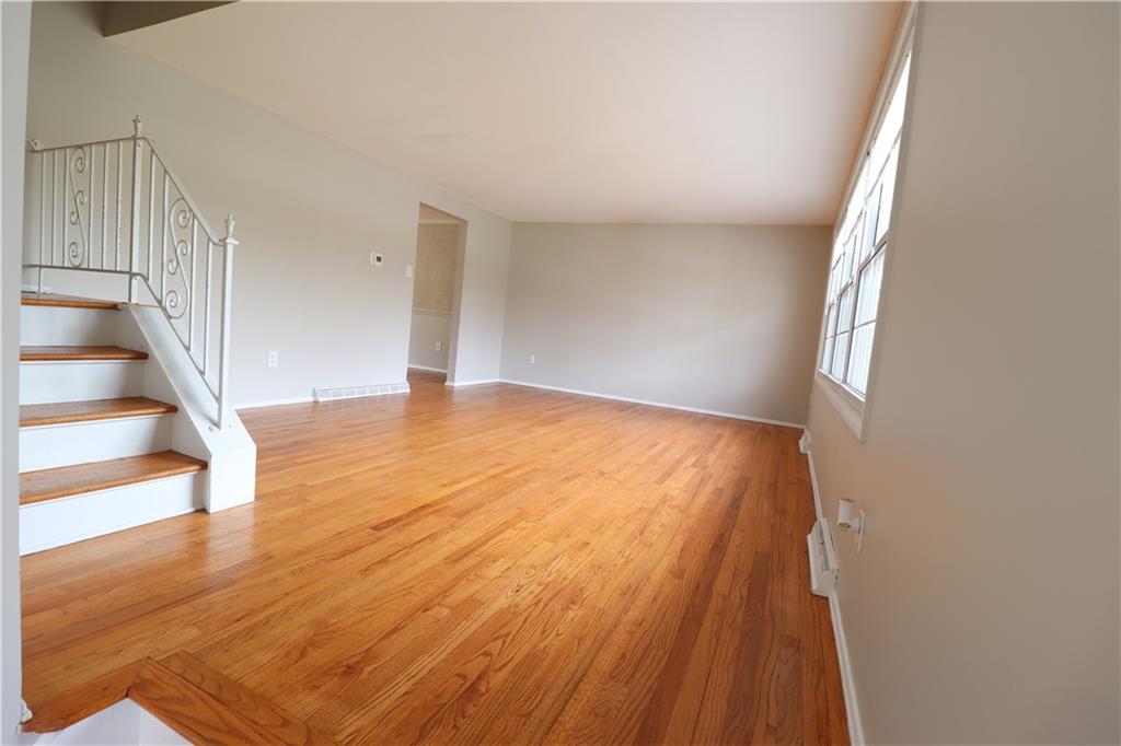 164 Friar Lane McMurray, PA 15317 - Photo 7 of 46 a view of an empty room with wooden floor and stairs