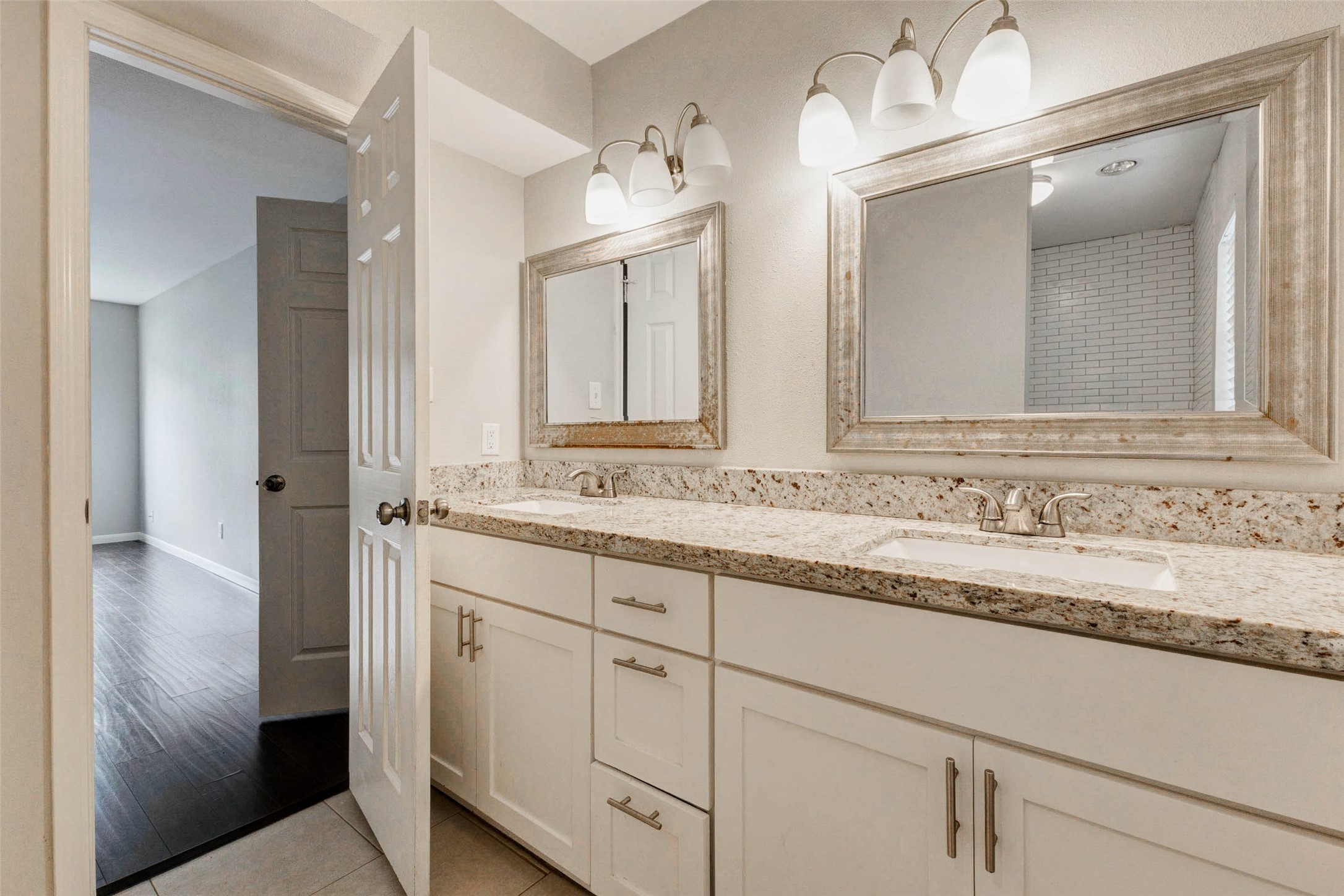 1622 Elk River Road Houston, TX 77090 - Photo 23 of 40 a bathroom with a granite countertop sink and a mirror