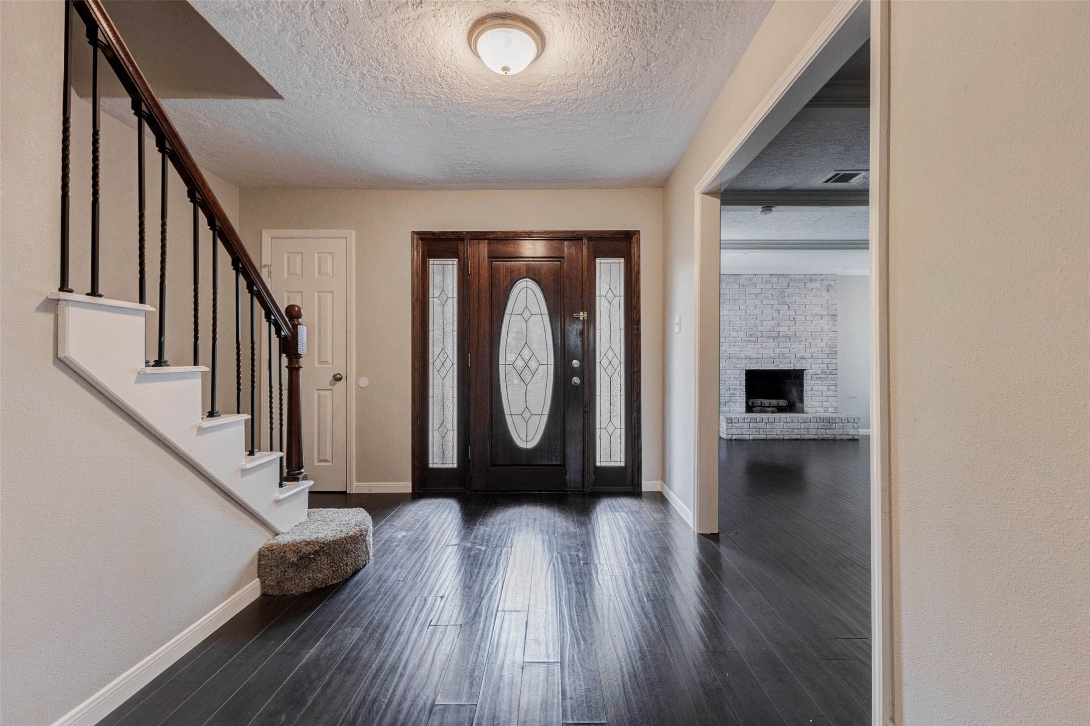 1622 Elk River Road Houston, TX 77090 - Photo 6 of 40 a view of a hallway with wooden floor and staircase