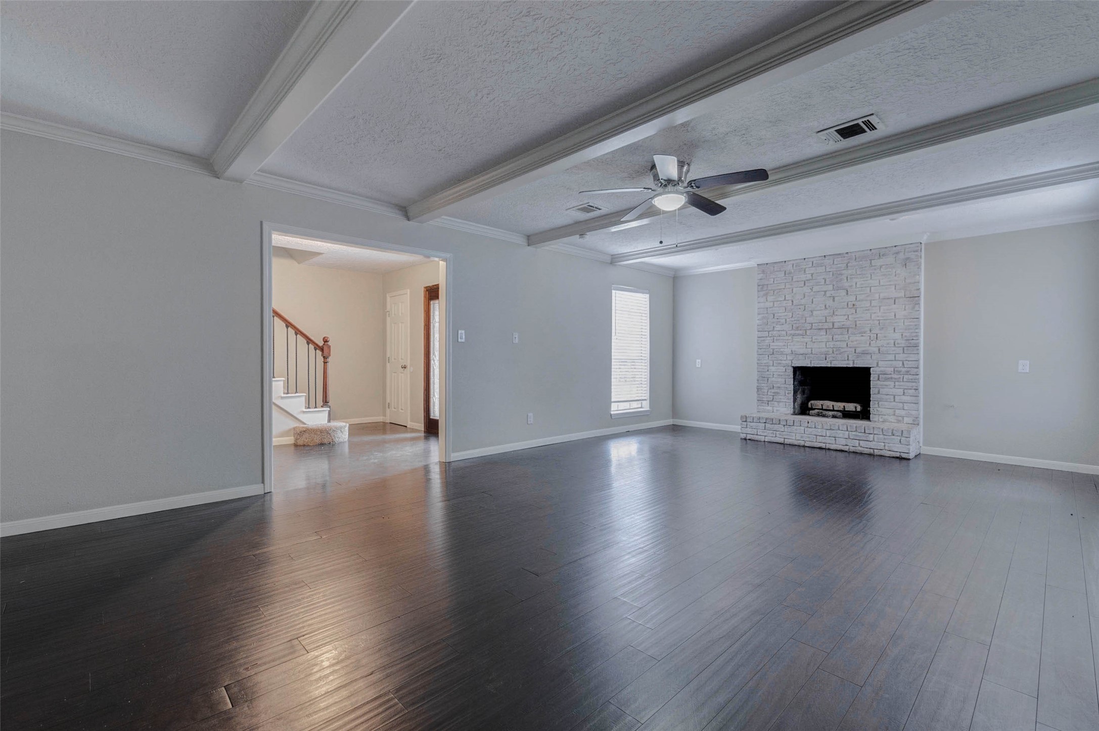 1622 Elk River Road Houston, TX 77090 - Photo 9 of 40 a view of a livingroom with wooden floor and a ceiling fan