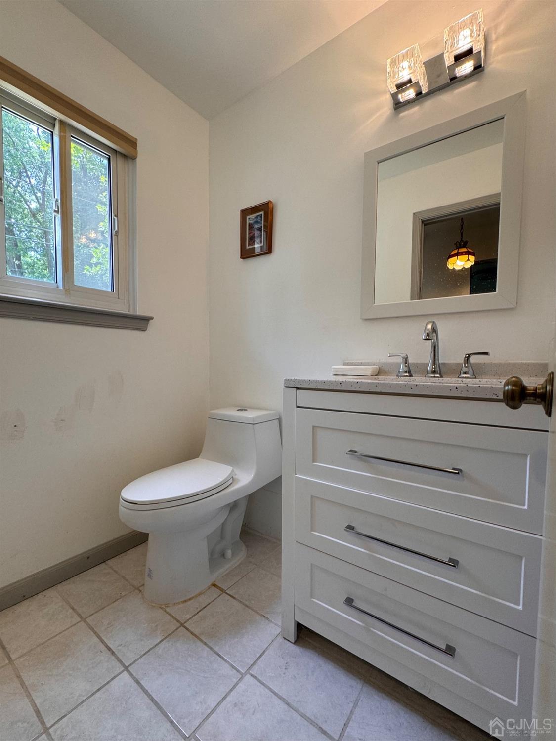155 Jefferson Boulevard Edison, NJ 08817 - Photo 11 of 21 a bathroom with a toilet sink and mirror