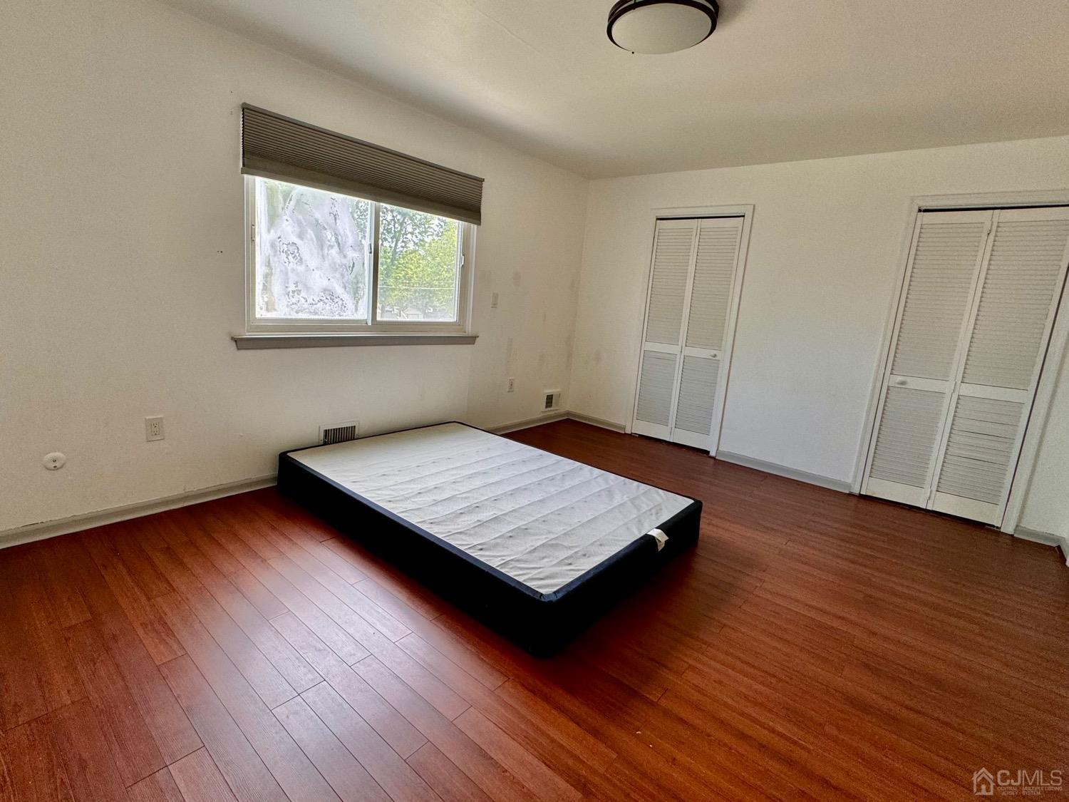 155 Jefferson Boulevard Edison, NJ 08817 - Photo 12 of 21 a room with wooden floor and window
