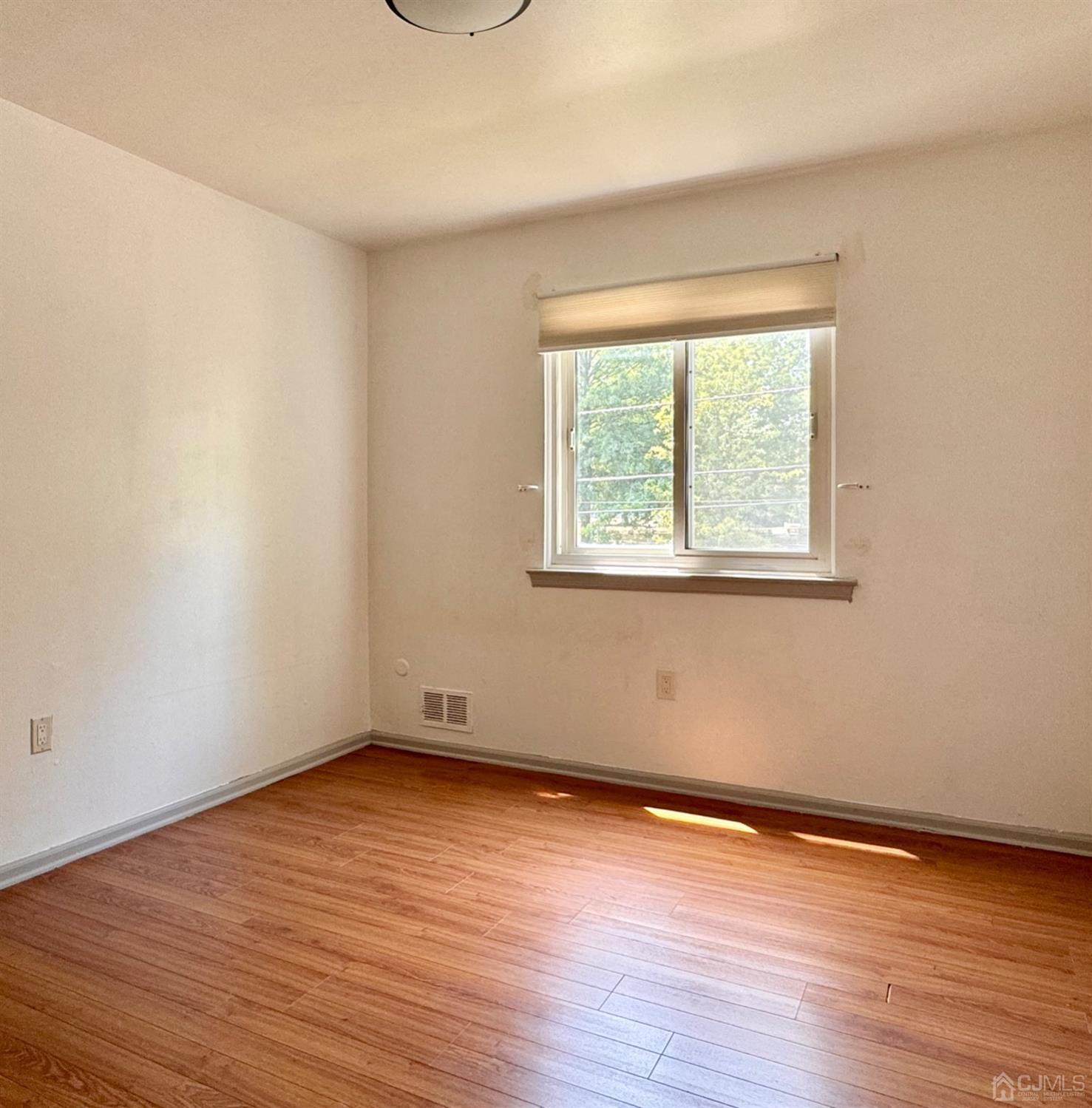 155 Jefferson Boulevard Edison, NJ 08817 - Photo 14 of 21 an empty room with wooden floor and windows