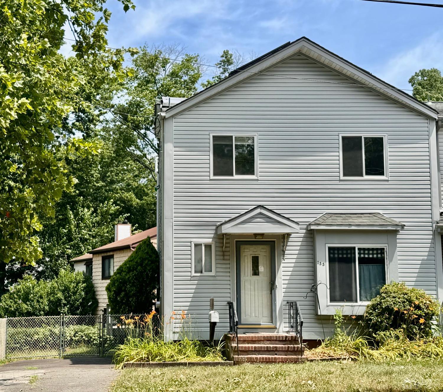 155 Jefferson Boulevard Edison, NJ 08817 - Photo 2 of 21 a front view of a house with a yard and potted plants