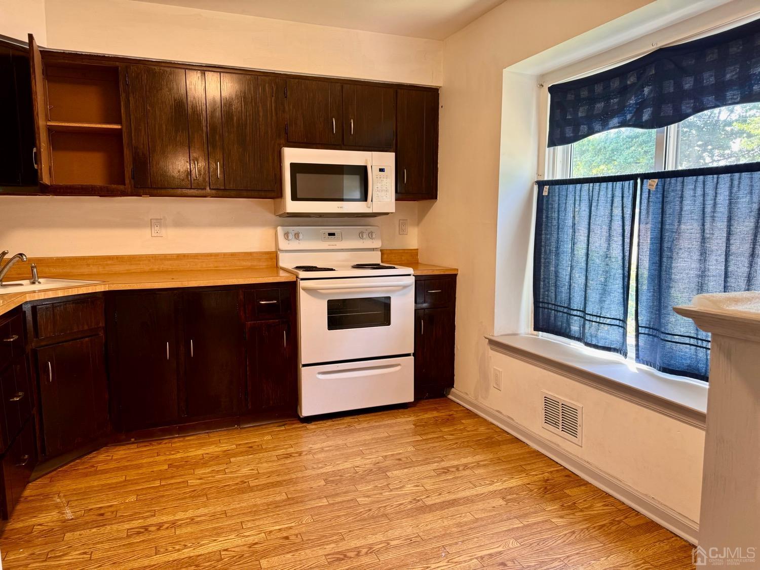 155 Jefferson Boulevard Edison, NJ 08817 - Photo 4 of 21 a kitchen with stainless steel appliances granite countertop a stove and a microwave