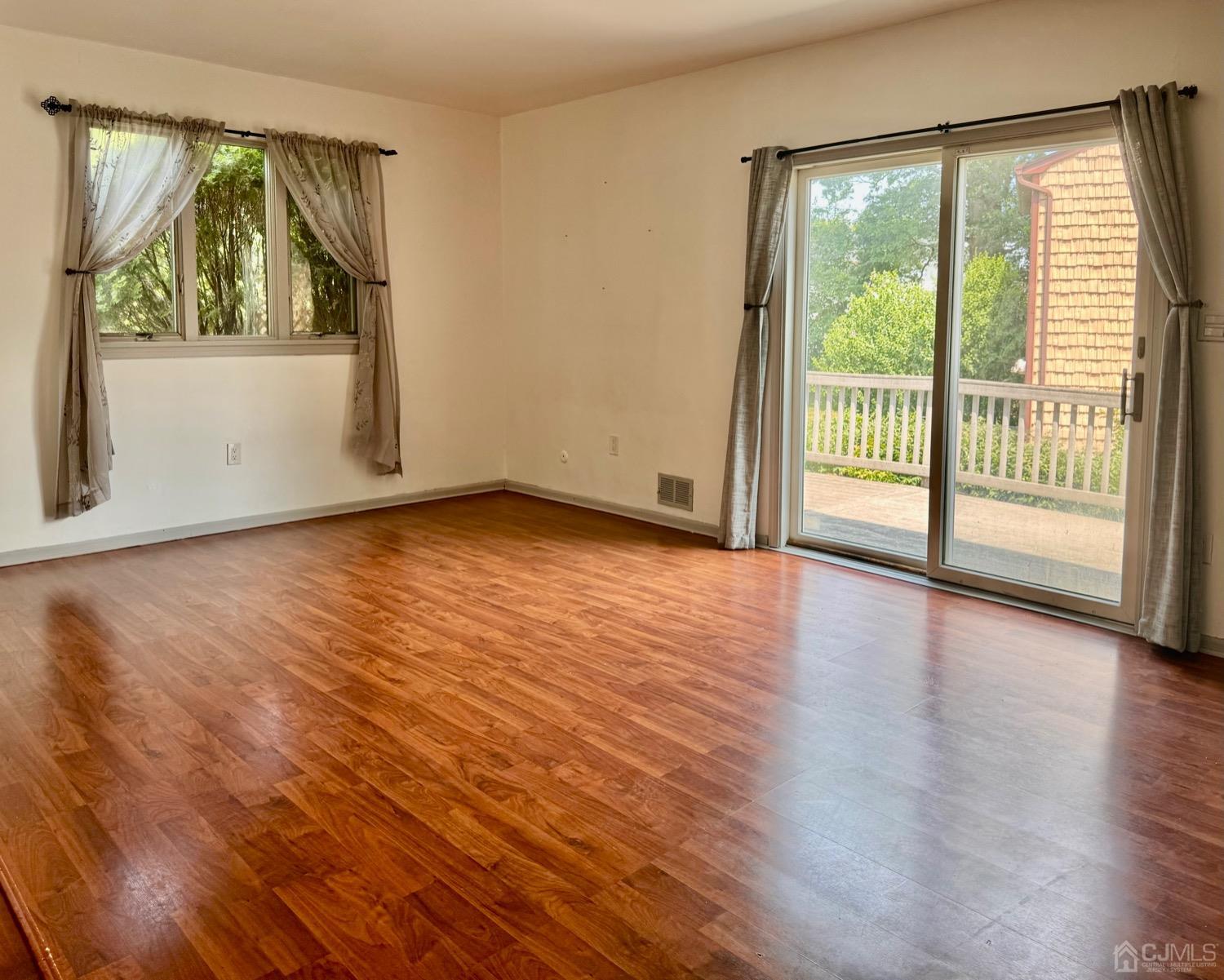 155 Jefferson Boulevard Edison, NJ 08817 - Photo 6 of 21 an empty room with wooden floor and windows