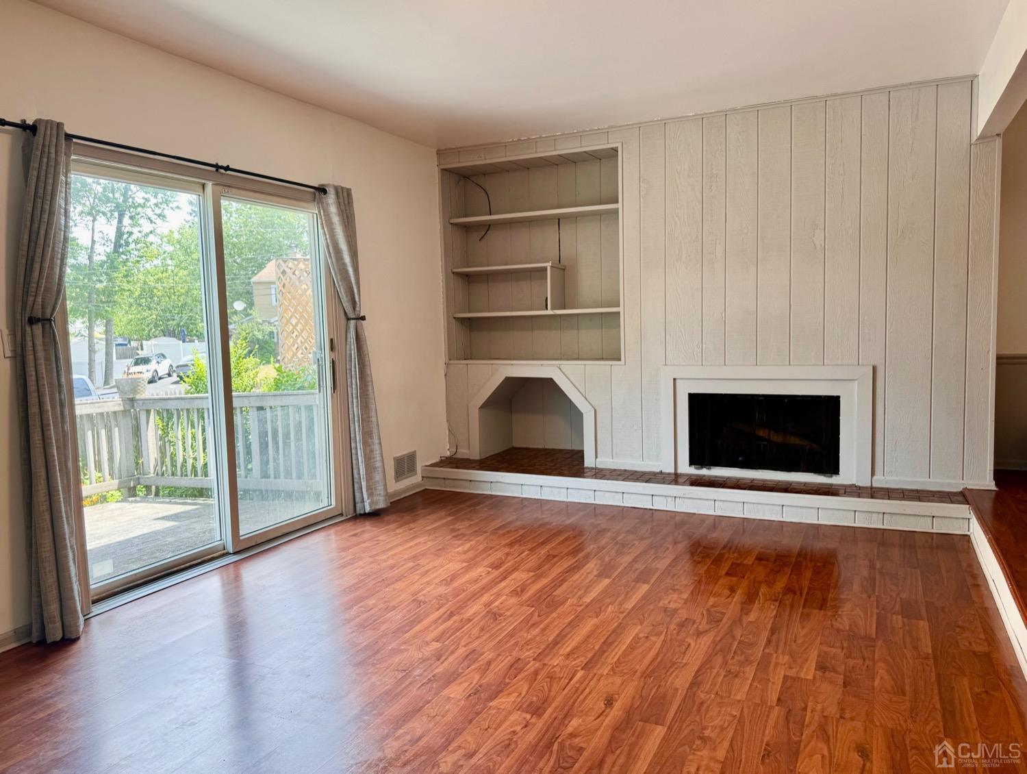 155 Jefferson Boulevard Edison, NJ 08817 - Photo 7 of 21 a view of empty room with wooden floor and fireplace