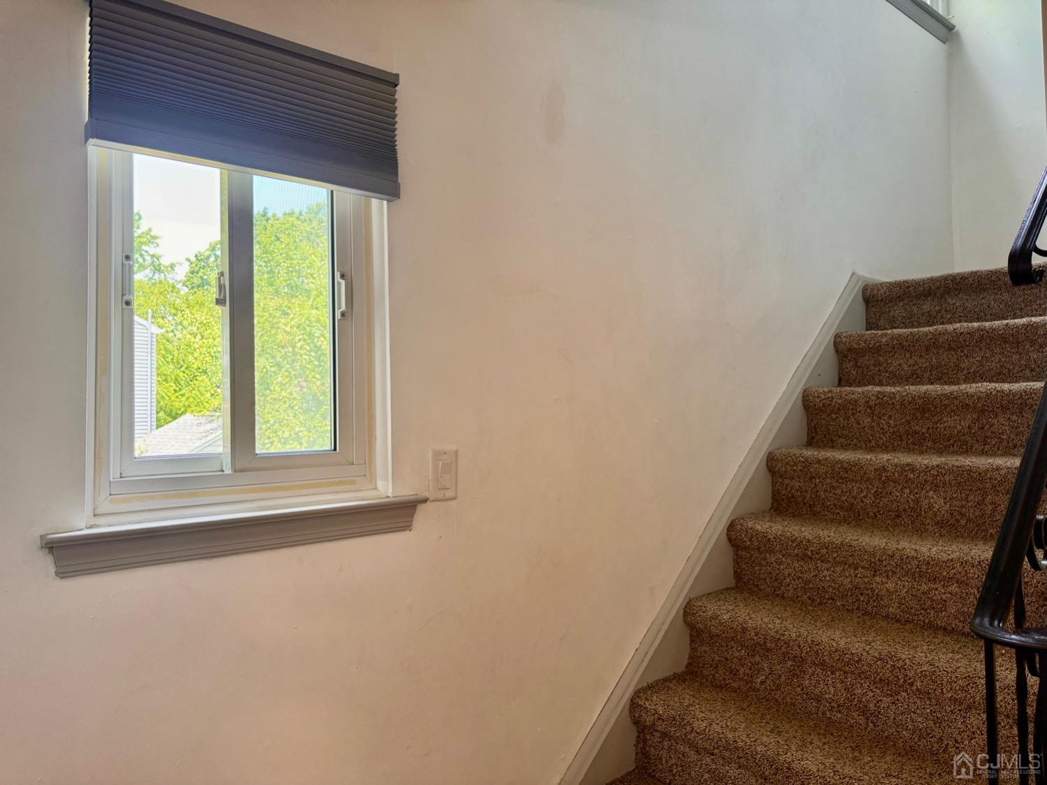 155 Jefferson Boulevard Edison, NJ 08817 - Photo 8 of 21 a view of staircase with wooden floor and a window