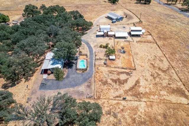 an aerial view of residential houses with outdoor space