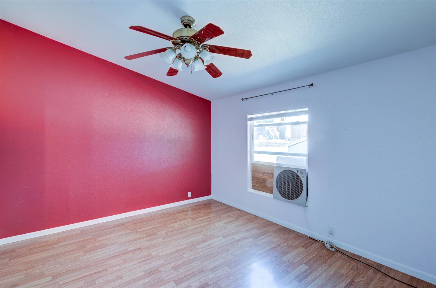 32748 Indian Guide Road Squaw Valley, CA 93675 - Photo 14 of 38 a view of an empty room with wooden floor and windows