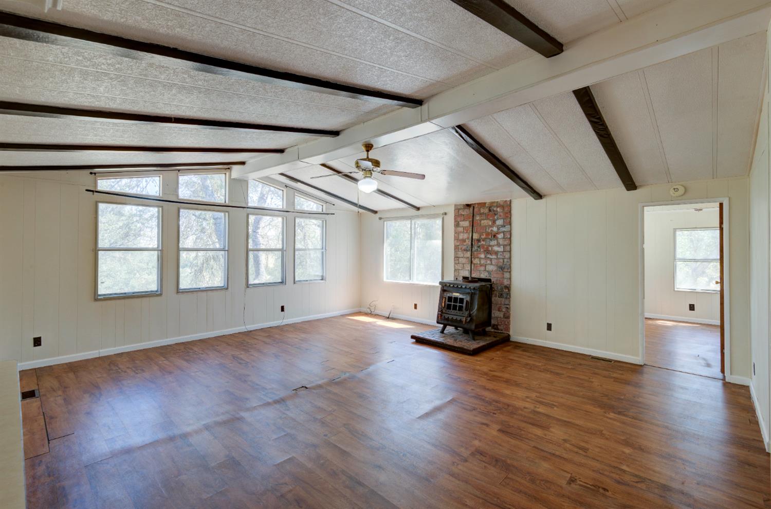 32748 Indian Guide Road Squaw Valley, CA 93675 - Photo 19 of 38 a view of empty room with wooden floor and windows