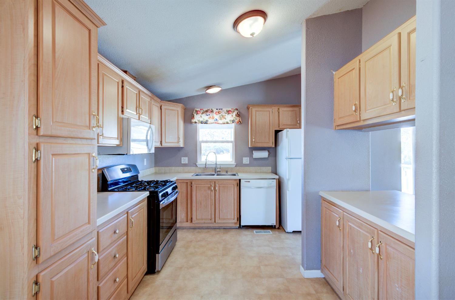 32748 Indian Guide Road Squaw Valley, CA 93675 - Photo 7 of 38 a kitchen with granite countertop a sink stove refrigerator and cabinets