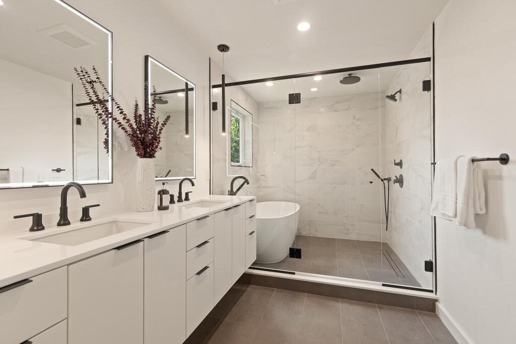 70 Walker Street, Unit 4 Newton, MA 02460 - Photo 17 of 35 a bathroom with a double vanity sink a toilet and a shower