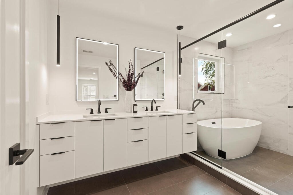70 Walker Street, Unit 4 Newton, MA 02460 - Photo 18 of 35 a spacious bathroom with a double vanity sink a mirror and a bathtub