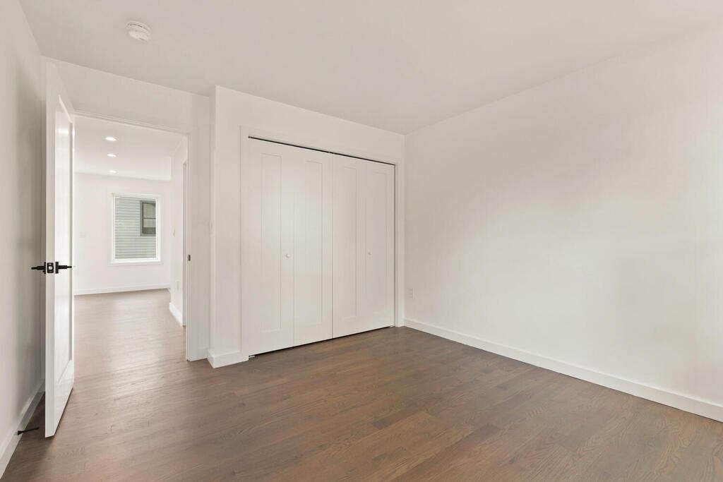 70 Walker Street, Unit 4 Newton, MA 02460 - Photo 21 of 35 an empty room with wooden floor and windows
