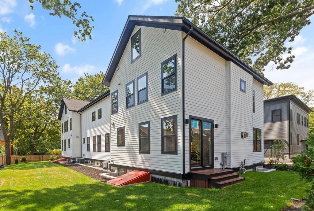 70 Walker Street, Unit 4 Newton, MA 02460 - Photo 30 of 35 a view of a white house with a big yard plants and large tree