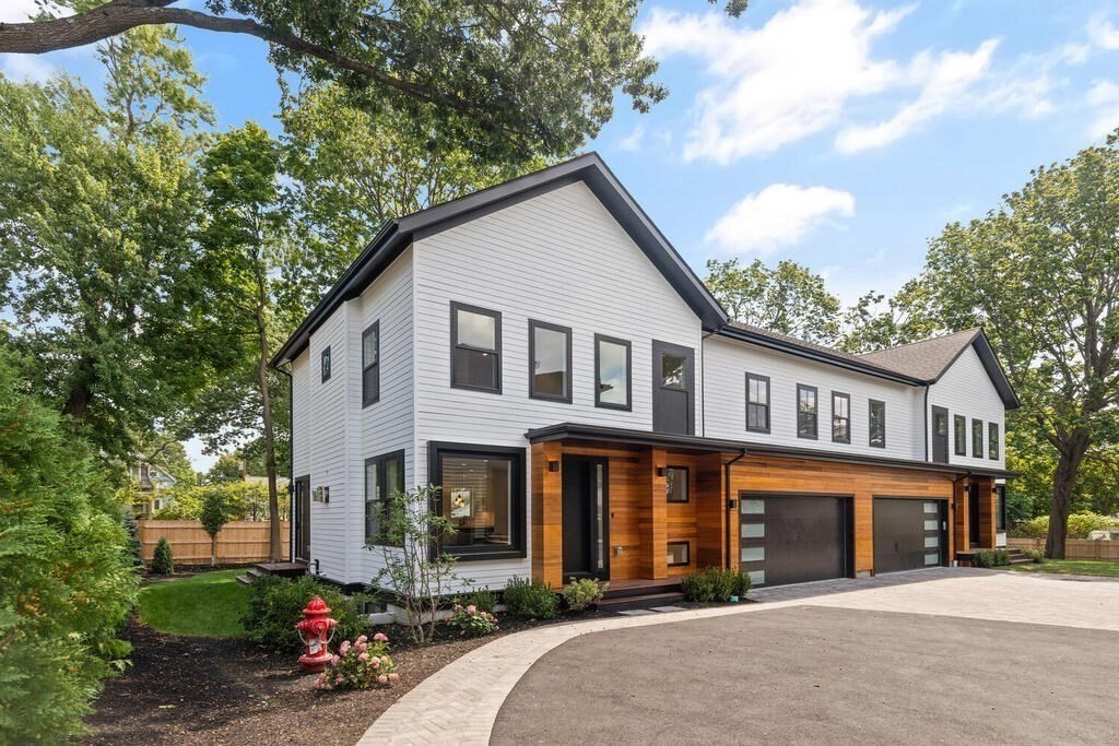 70 Walker Street, Unit 4 Newton, MA 02460 - Photo 32 of 35 a front view of a house with a yard and garage