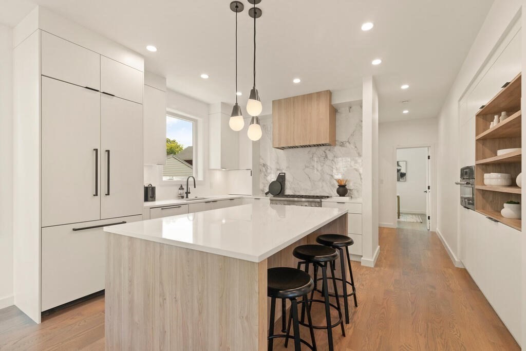 70 Walker Street, Unit 4 Newton, MA 02460 - Photo 5 of 35 a kitchen with stainless steel appliances granite countertop a sink a stove a refrigerator and island with wooden floor