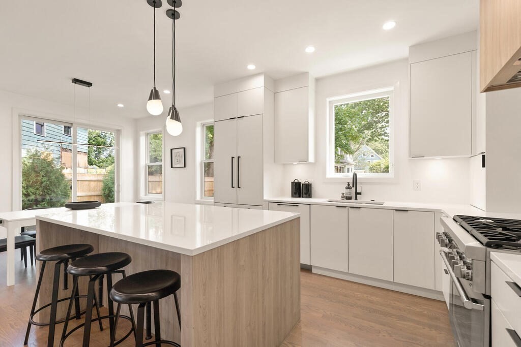 70 Walker Street, Unit 4 Newton, MA 02460 - Photo 6 of 35 a kitchen with granite countertop a sink a center island and cabinets