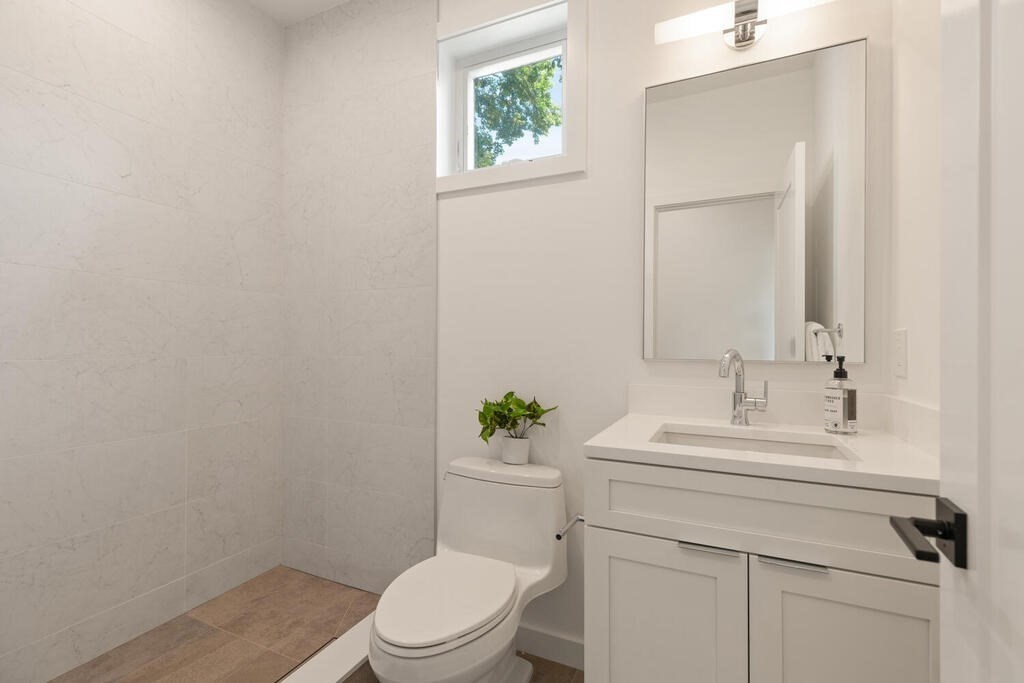 70 Walker Street, Unit 4 Newton, MA 02460 - Photo 10 of 35 a bathroom with a sink a toilet and a mirror