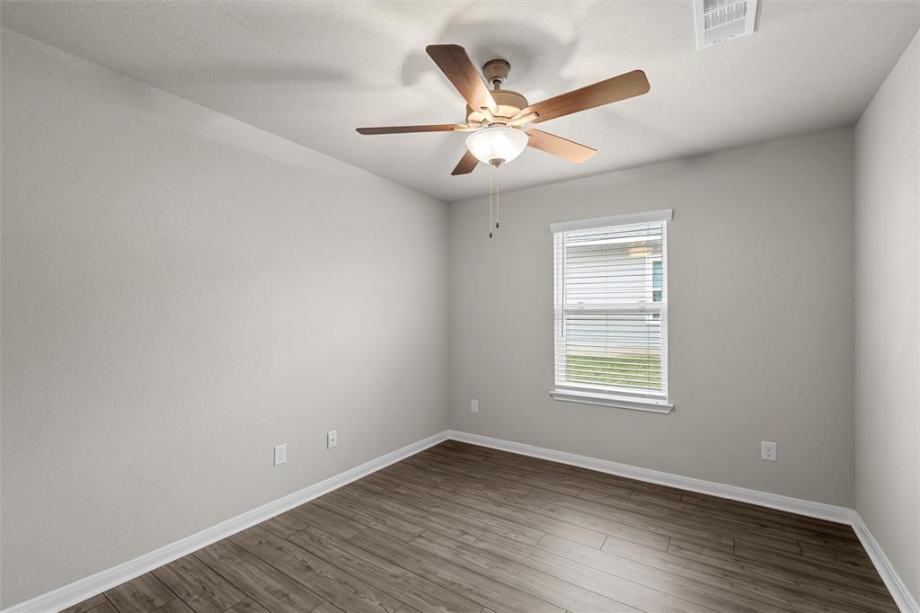 3208 Dottavio Road Lorena, TX 76655 - Photo 21 of 31 Room featuring wood-finish flooring, light grey painted walls, and white baseboards