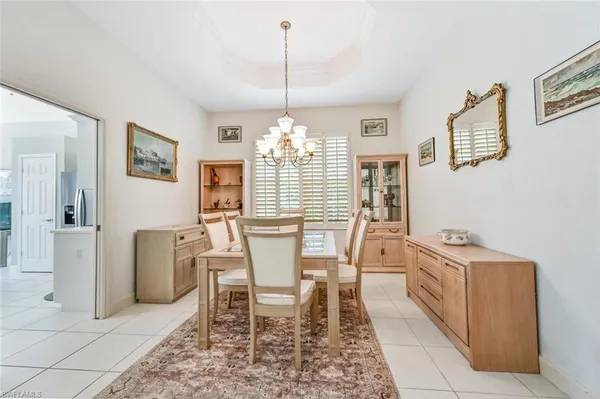 a view of a dining room with furniture and chandelier