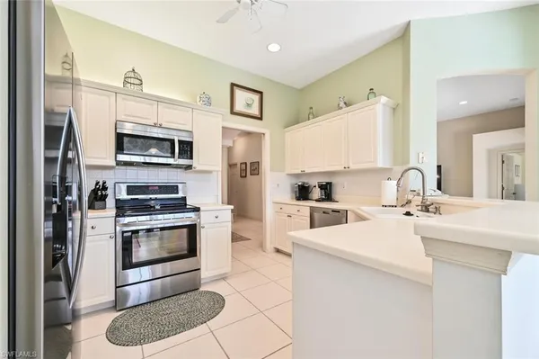 a kitchen with stainless steel appliances a stove sink microwave and cabinets