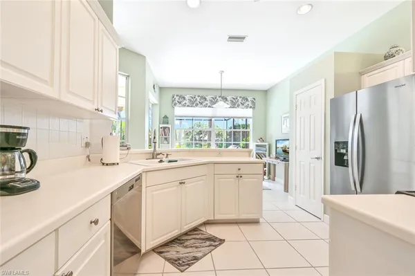 a kitchen with a sink stove and refrigerator