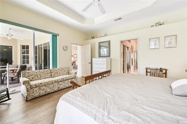 a spacious bedroom with two beds and a large mirror