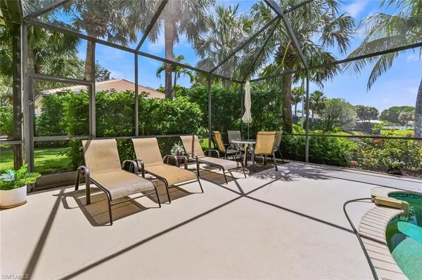 a view of a patio with a table and chairs