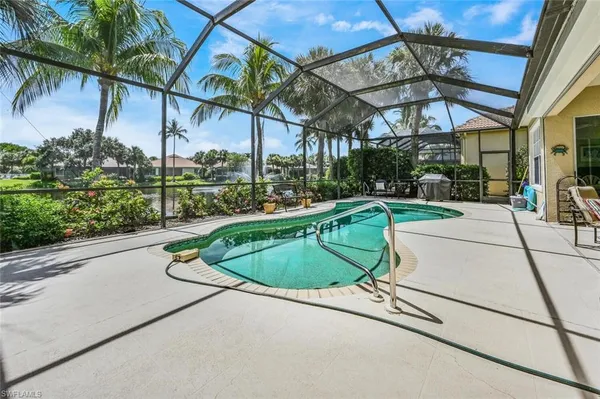 a view of a swimming pool with a patio and a garden