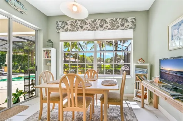 a view of a dining room with furniture large windows and wooden floor