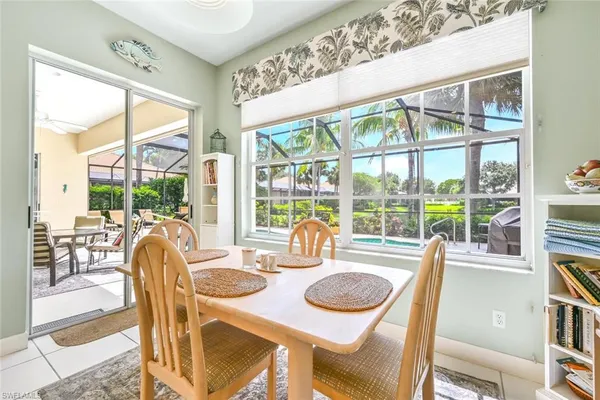 a dining room with furniture water view and balcony