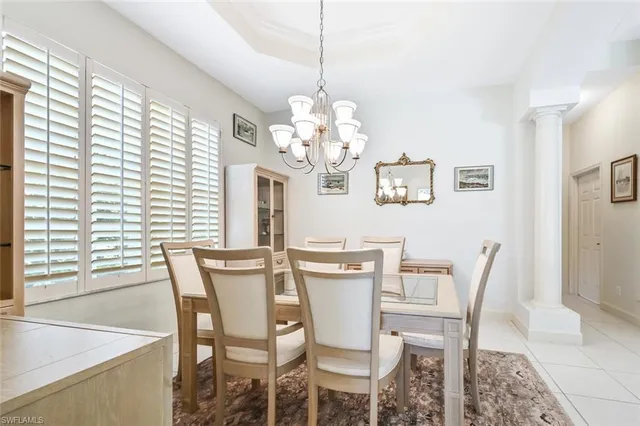 a view of a dining room with furniture and chandelier