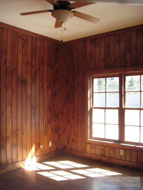 145-8 Banner Road Southwest, Unit 8 Banner Elk, NC 28604 - Photo 22 of 22 an empty room with wooden floor and windows