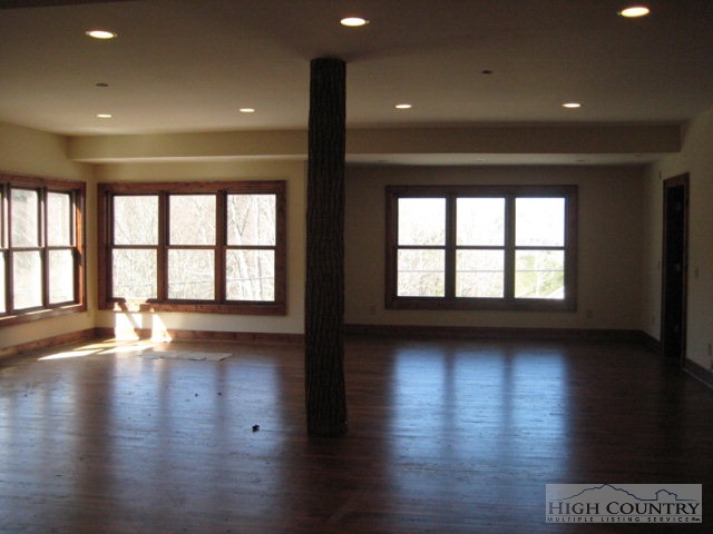 145-8 Banner Road Southwest, Unit 8 Banner Elk, NC 28604 - Photo 8 of 22 a view of an empty room with wooden floor and a window