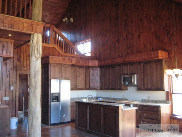 145-8 Banner Road Southwest, Unit 8 Banner Elk, NC 28604 - Photo 10 of 22 a kitchen with stainless steel appliances granite countertop wooden cabinets a refrigerator and a sink
