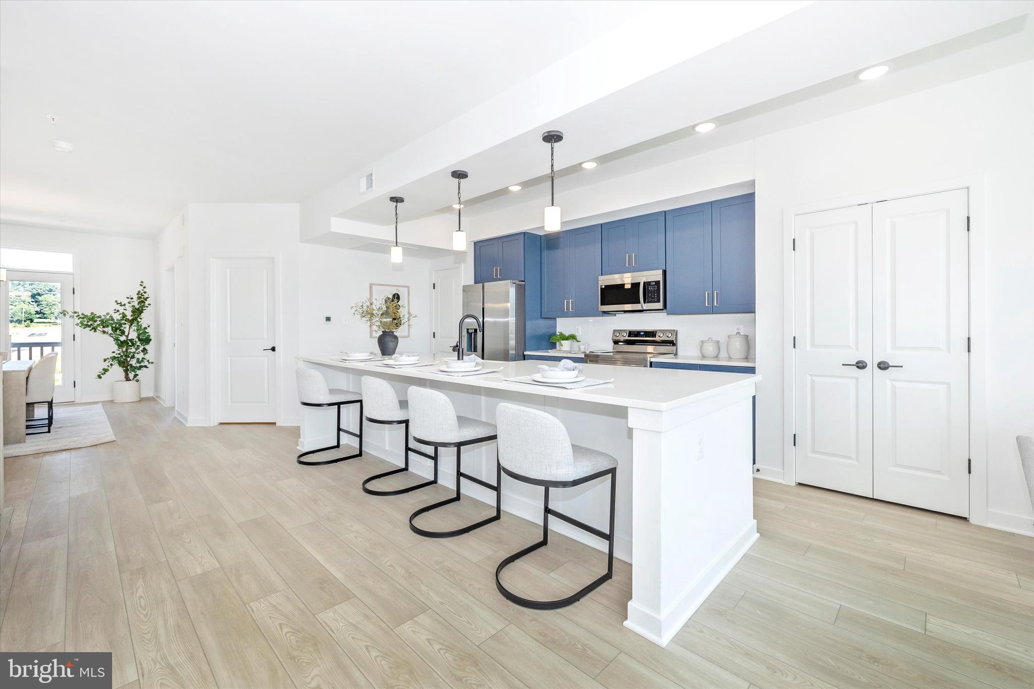 1631 A Blacksmith Way Frederick, MD 21702 - Photo 12 of 35 a kitchen with kitchen island granite countertop a sink cabinets and stainless steel appliances