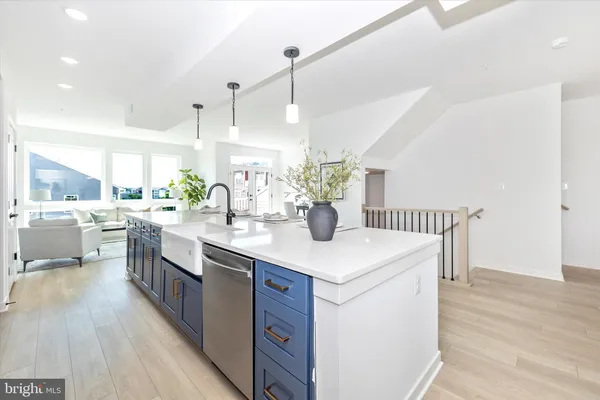 a kitchen with a sink a counter top space and stainless steel appliances