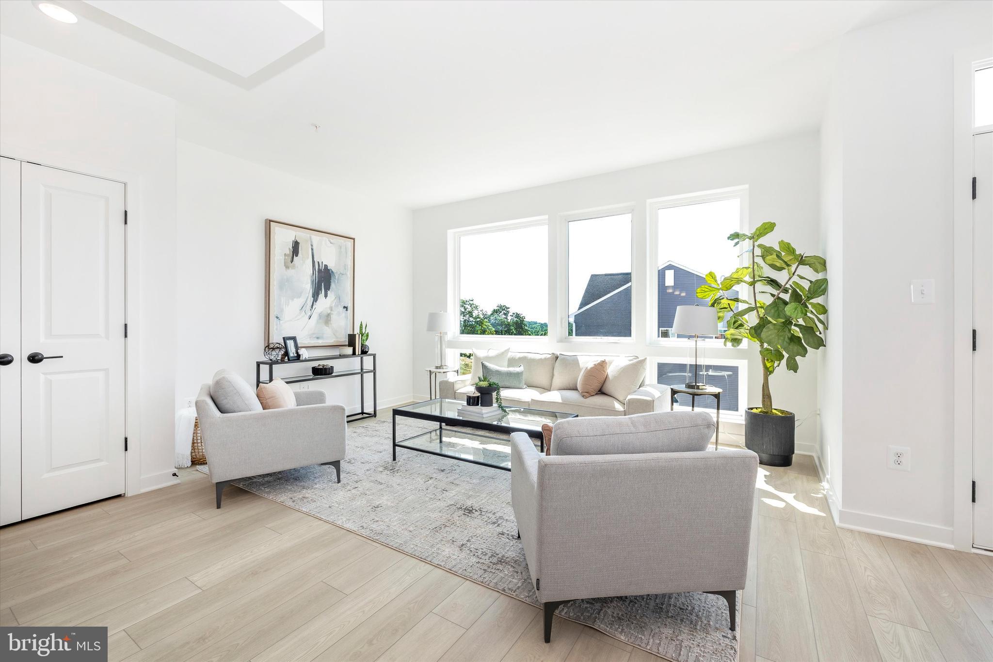 1631 A Blacksmith Way Frederick, MD 21702 - Photo 14 of 35 a living room with furniture and a potted plant