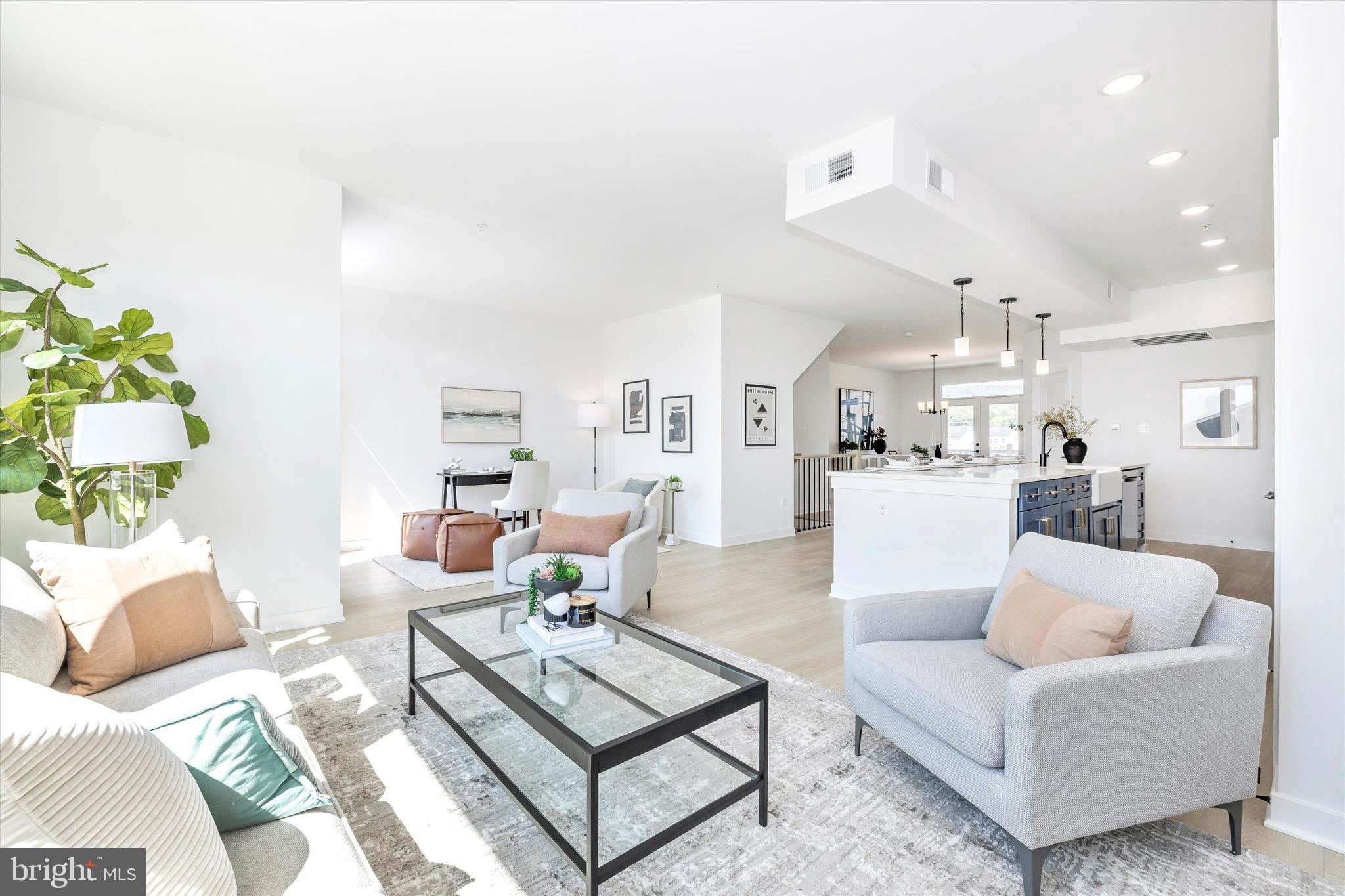 1631 A Blacksmith Way Frederick, MD 21702 - Photo 17 of 35 a living room with furniture and a view of kitchen