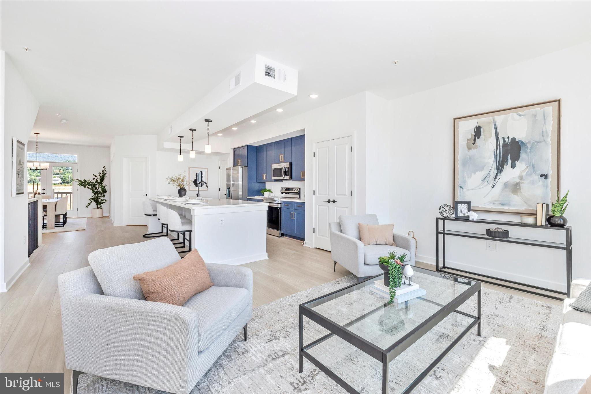 1631 A Blacksmith Way Frederick, MD 21702 - Photo 18 of 35 a living room with furniture and kitchen view