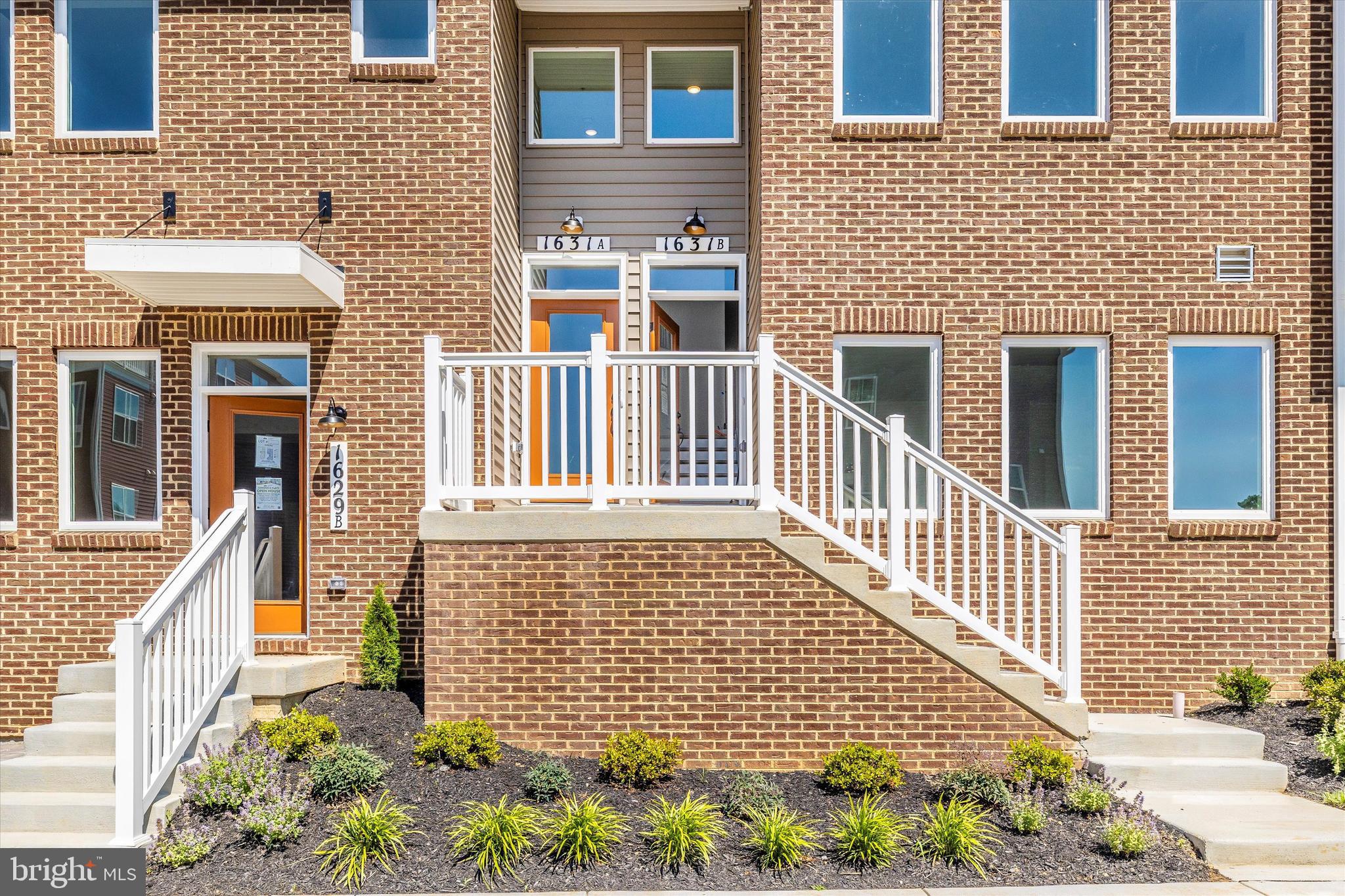 1631 A Blacksmith Way Frederick, MD 21702 - Photo 2 of 35 a front view of a house with a garden
