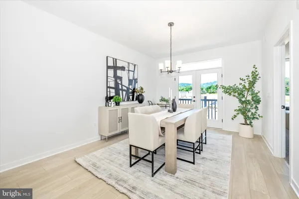 a dining room with furniture window and wooden floor