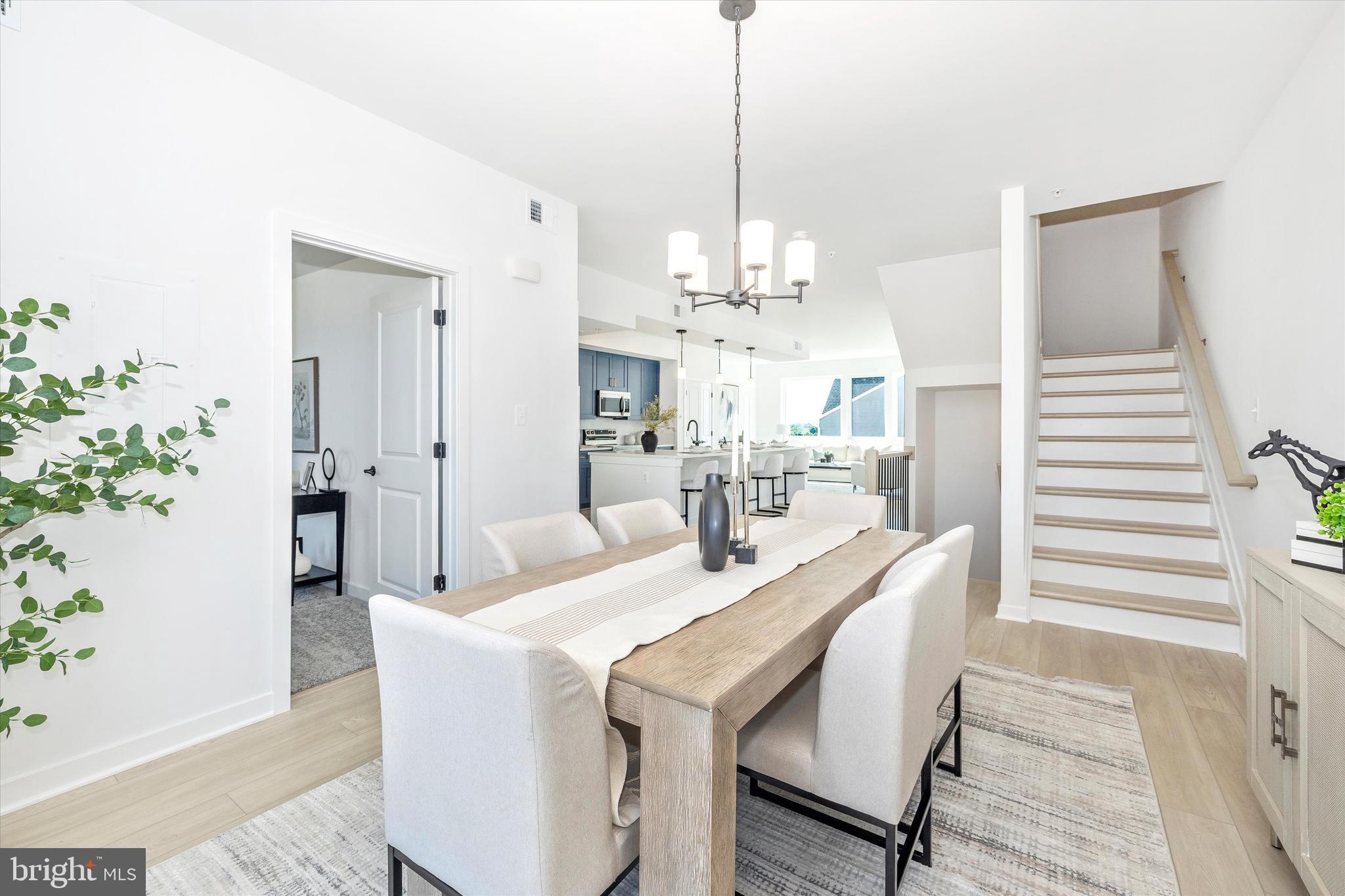 1631 A Blacksmith Way Frederick, MD 21702 - Photo 7 of 35 a dining room with chandelier and wooden floor
