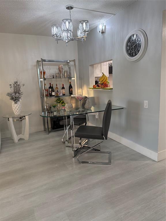 9360 Lime Bay Boulevard, Unit 202 Tamarac, FL 33321 - Photo 11 of 15 a view of a dining room with furniture