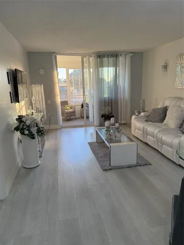 a living room with furniture and floor to ceiling windows
