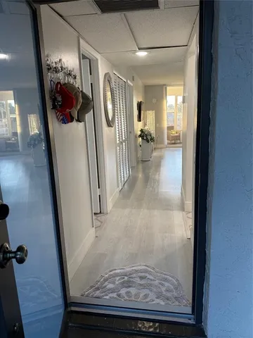 a view of a hallway view window and wooden floor